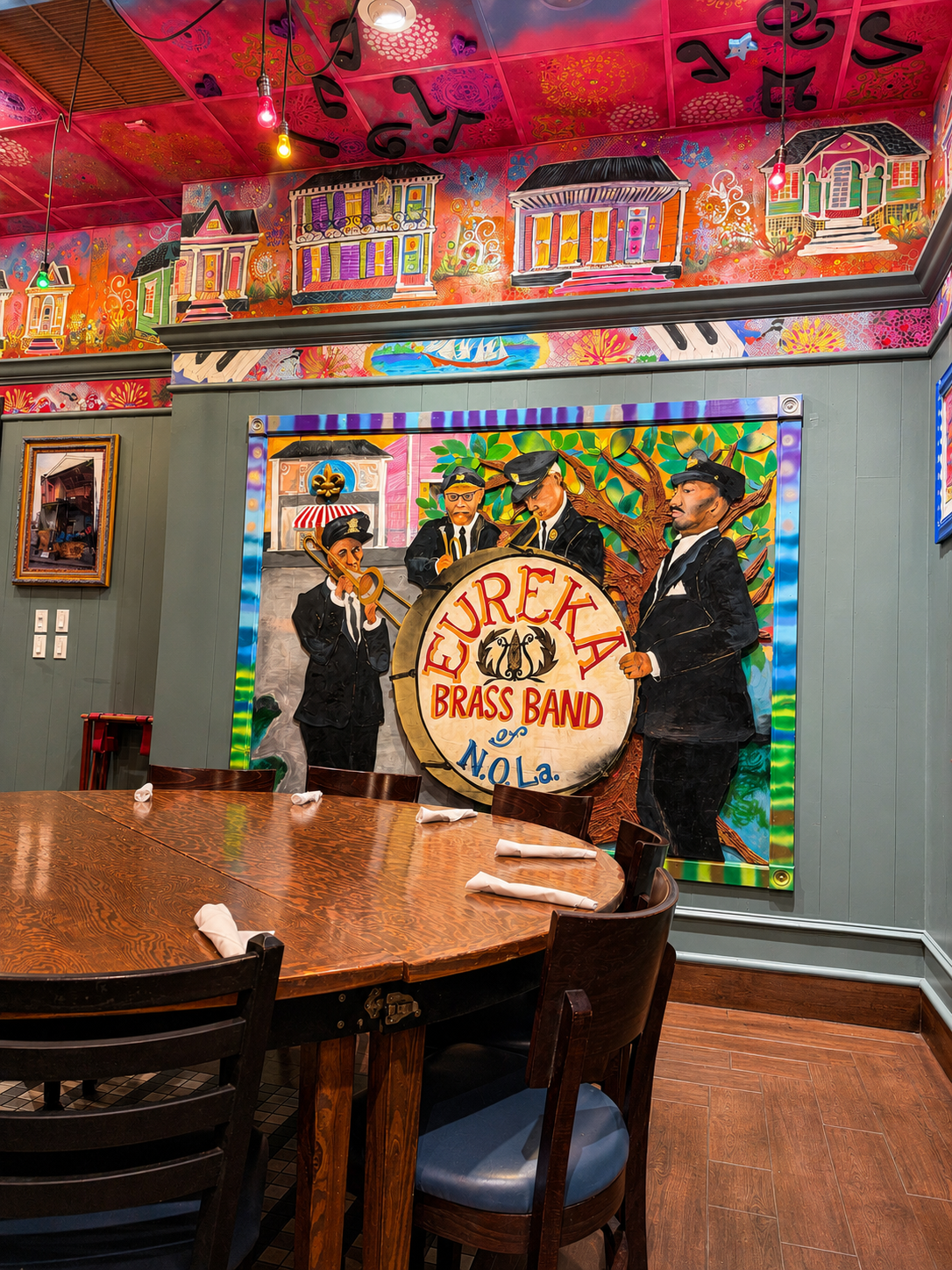 Eureka Brass Band mural beside the long dining table in the Napoleon Room at Tibby's Winter Park